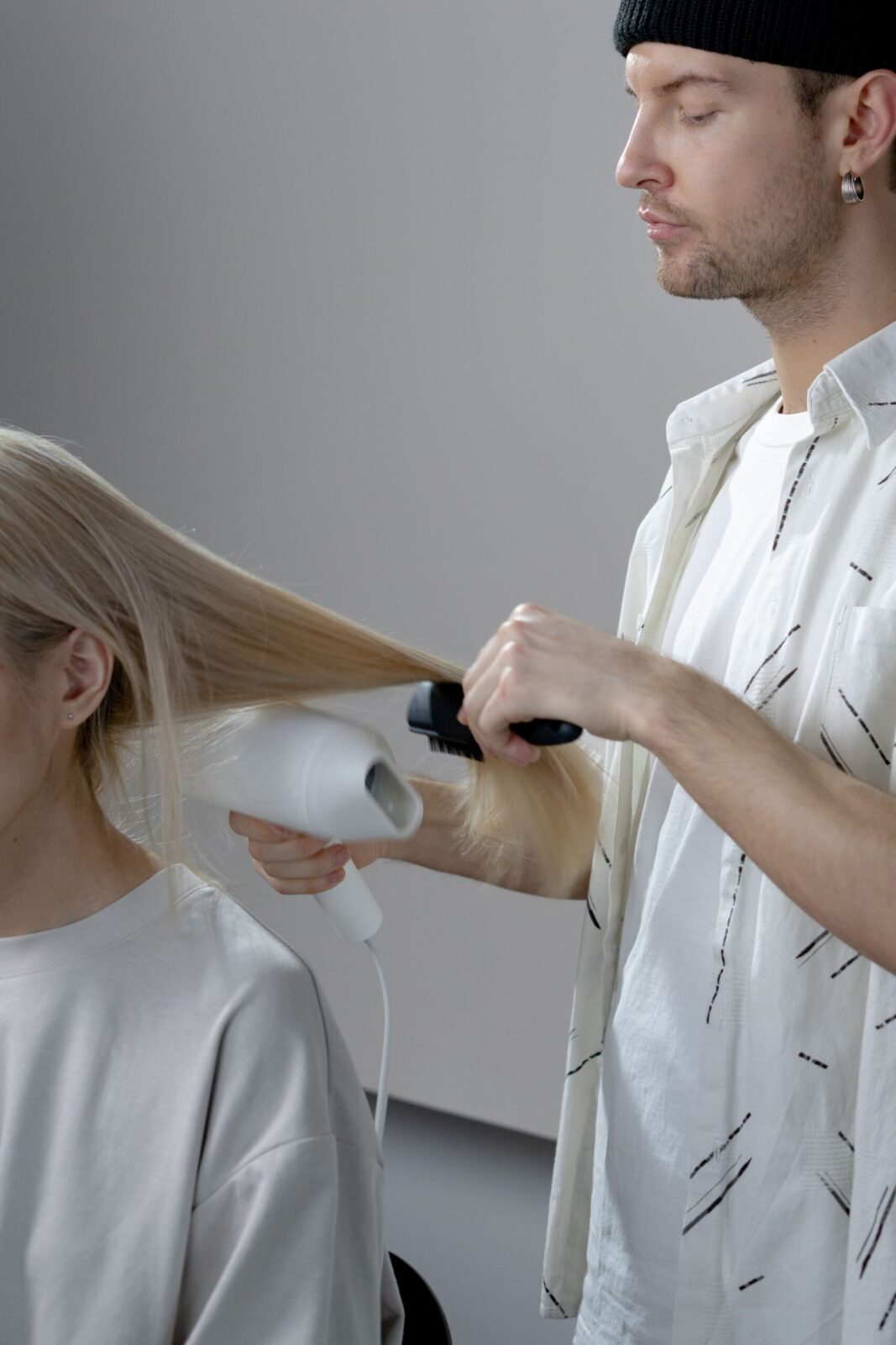 A stylist blow-drying a client at CHAIR