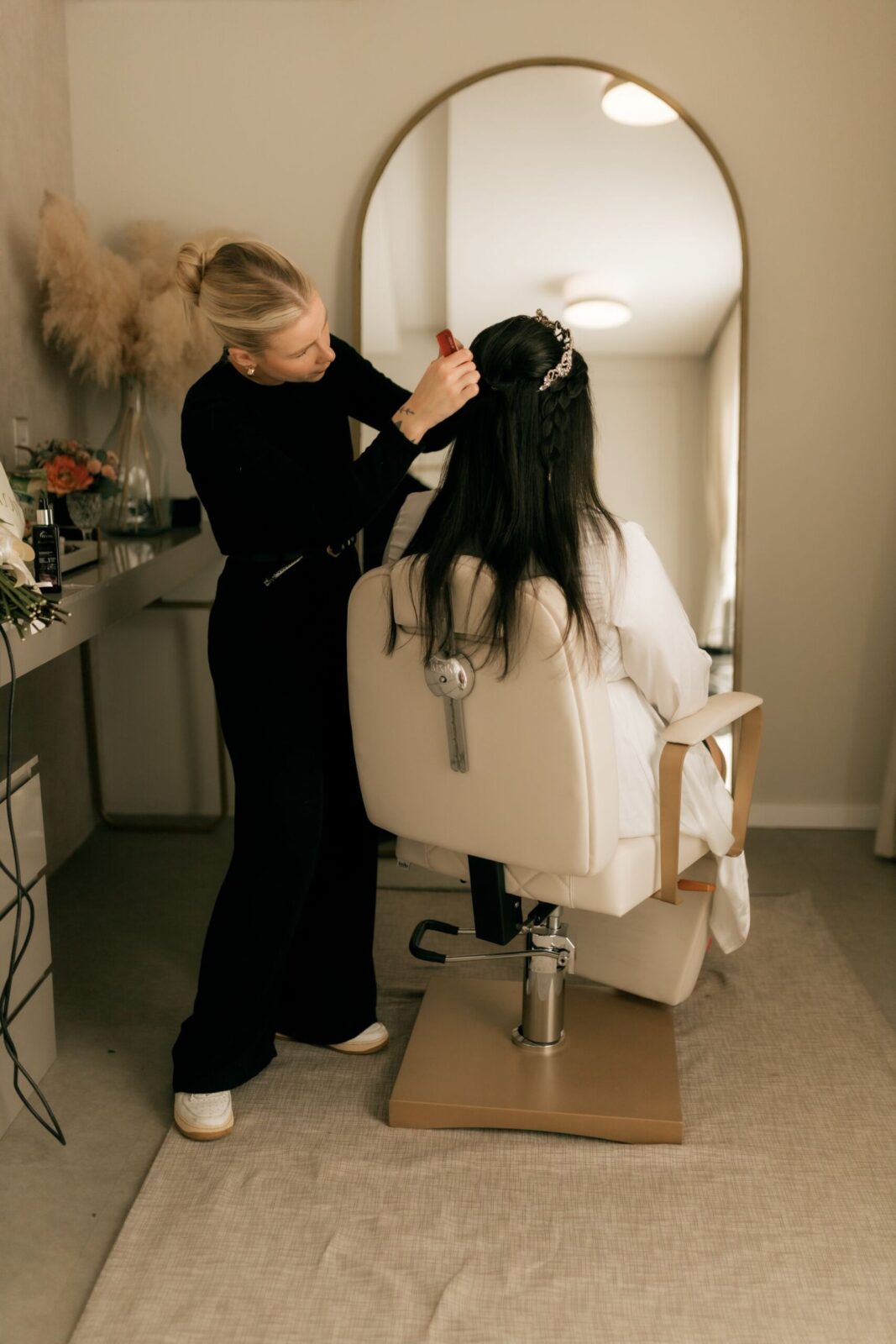 A stylist preparing a bride at CHAIR