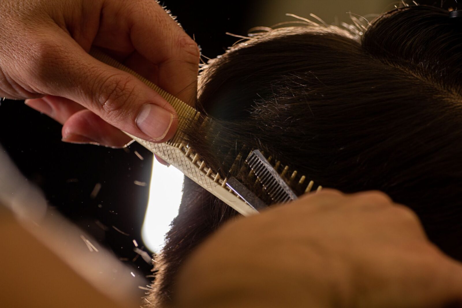 A stylist cutting hair at CHAIR