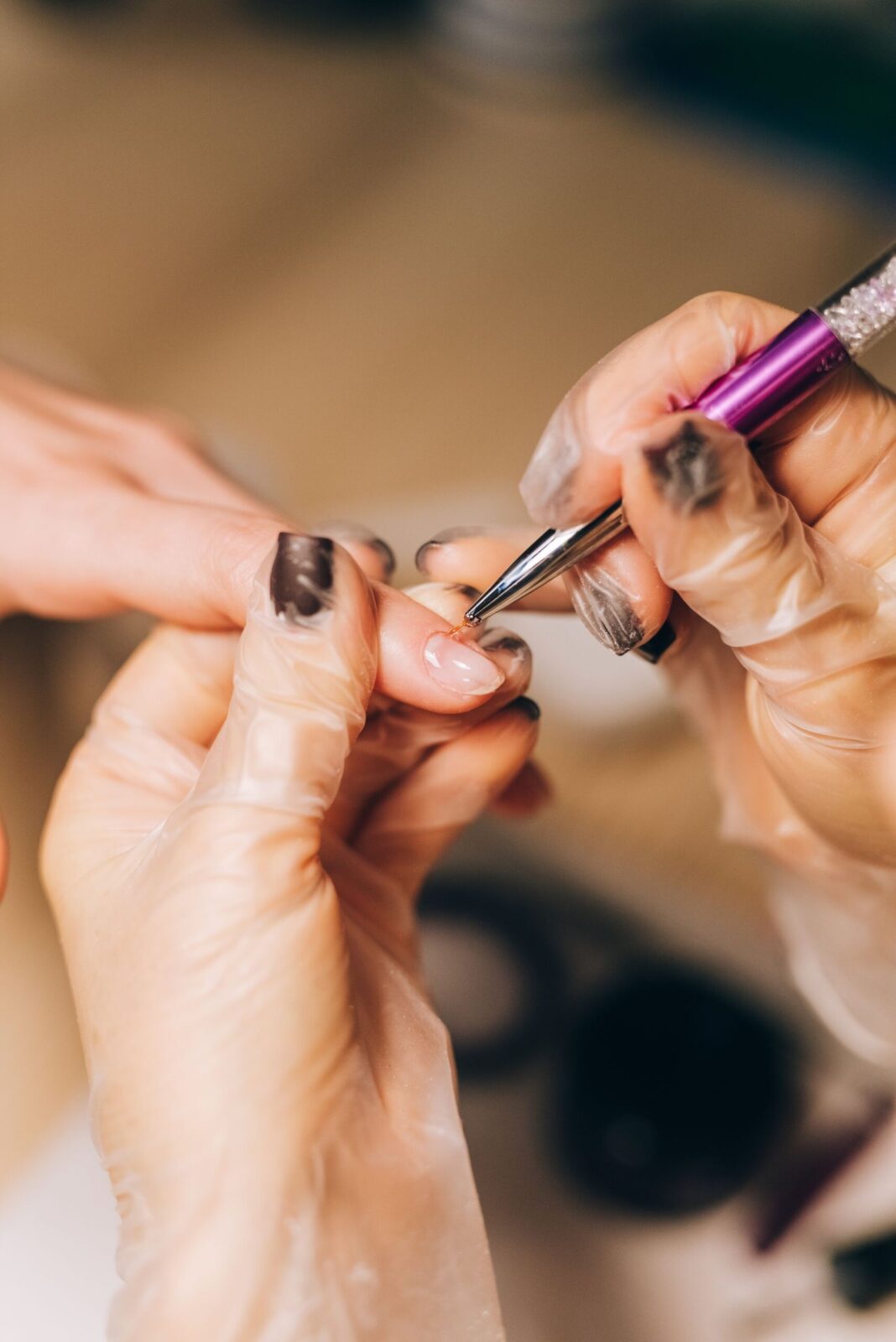 A nail technician working at the CHAIR nail table