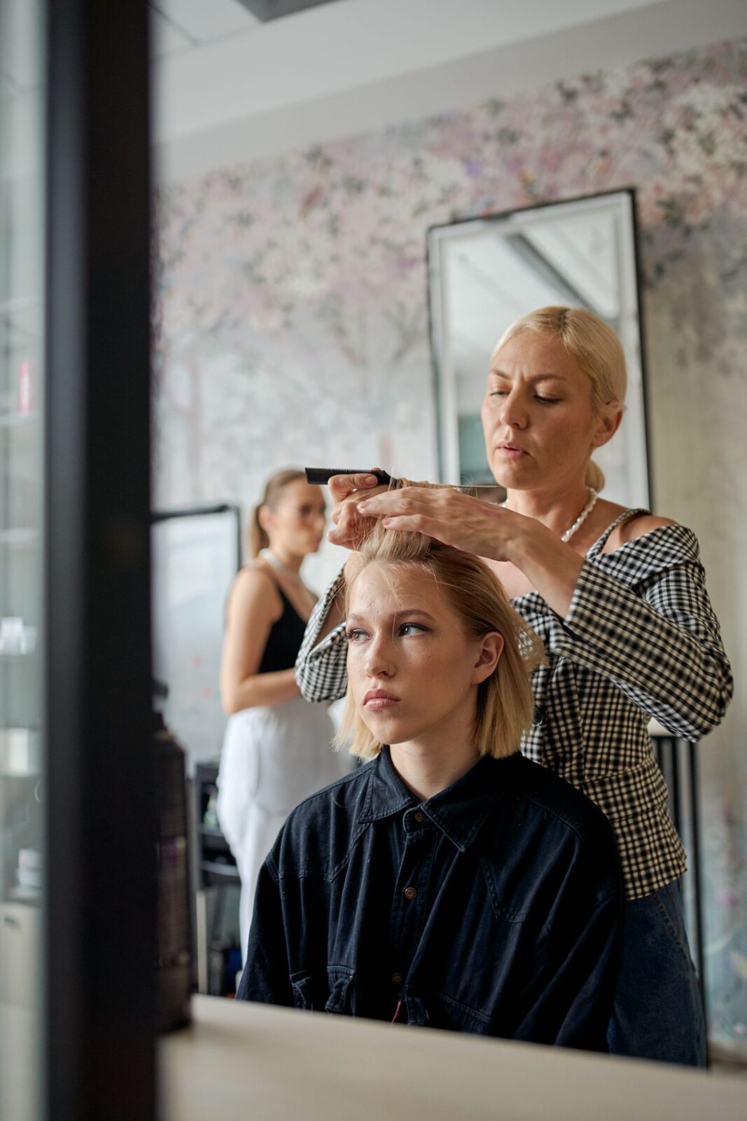 A stylist straightening a client hair at CHAIR